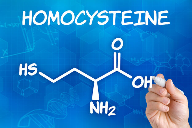 Hand with pen drawing the chemical formula of homocysteine